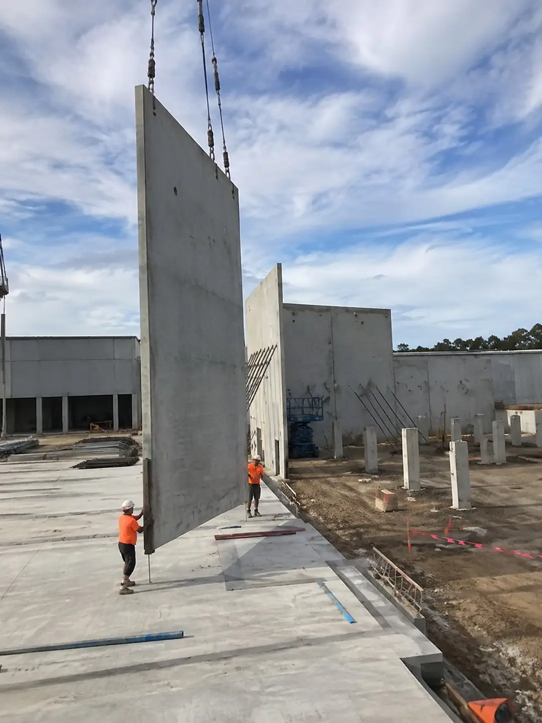 Concrete tilt-up wall panels being stood on an industrial site