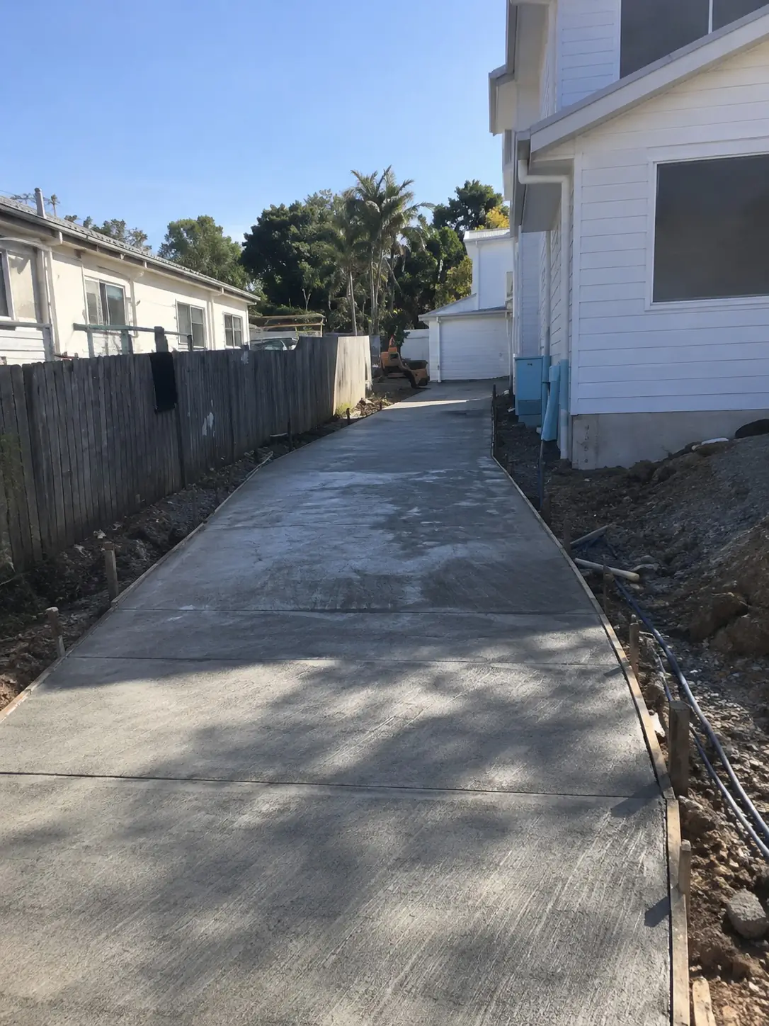 New plain concrete driveway beside a Wollongong home