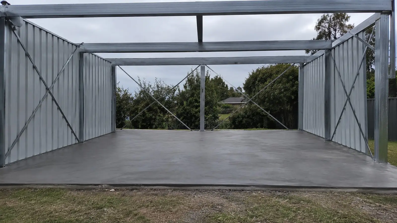 Concrete slab inside a new steel shed frame in Wollongong