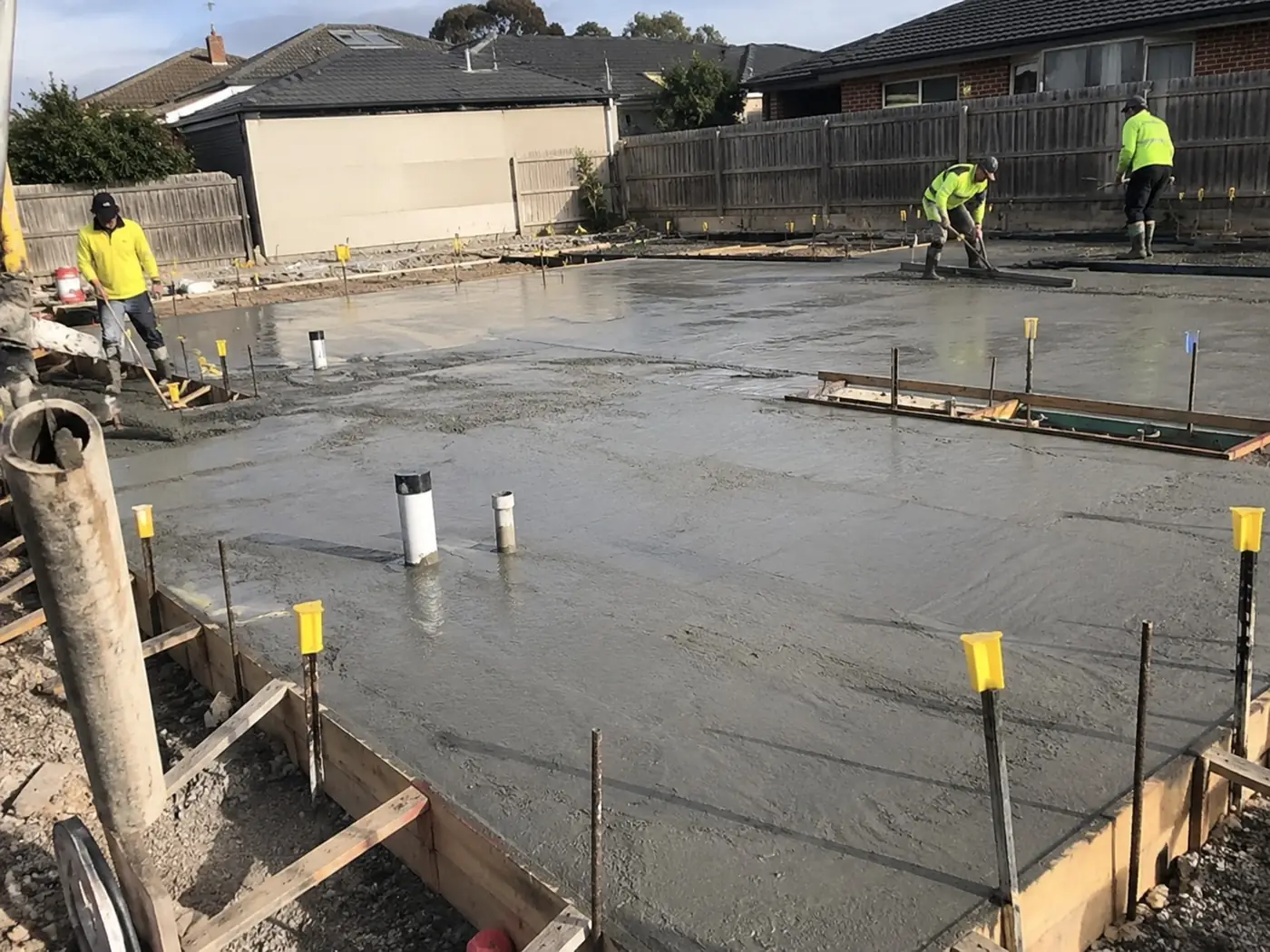 Crew screeding a reinforced structural concrete slab in Wollongong