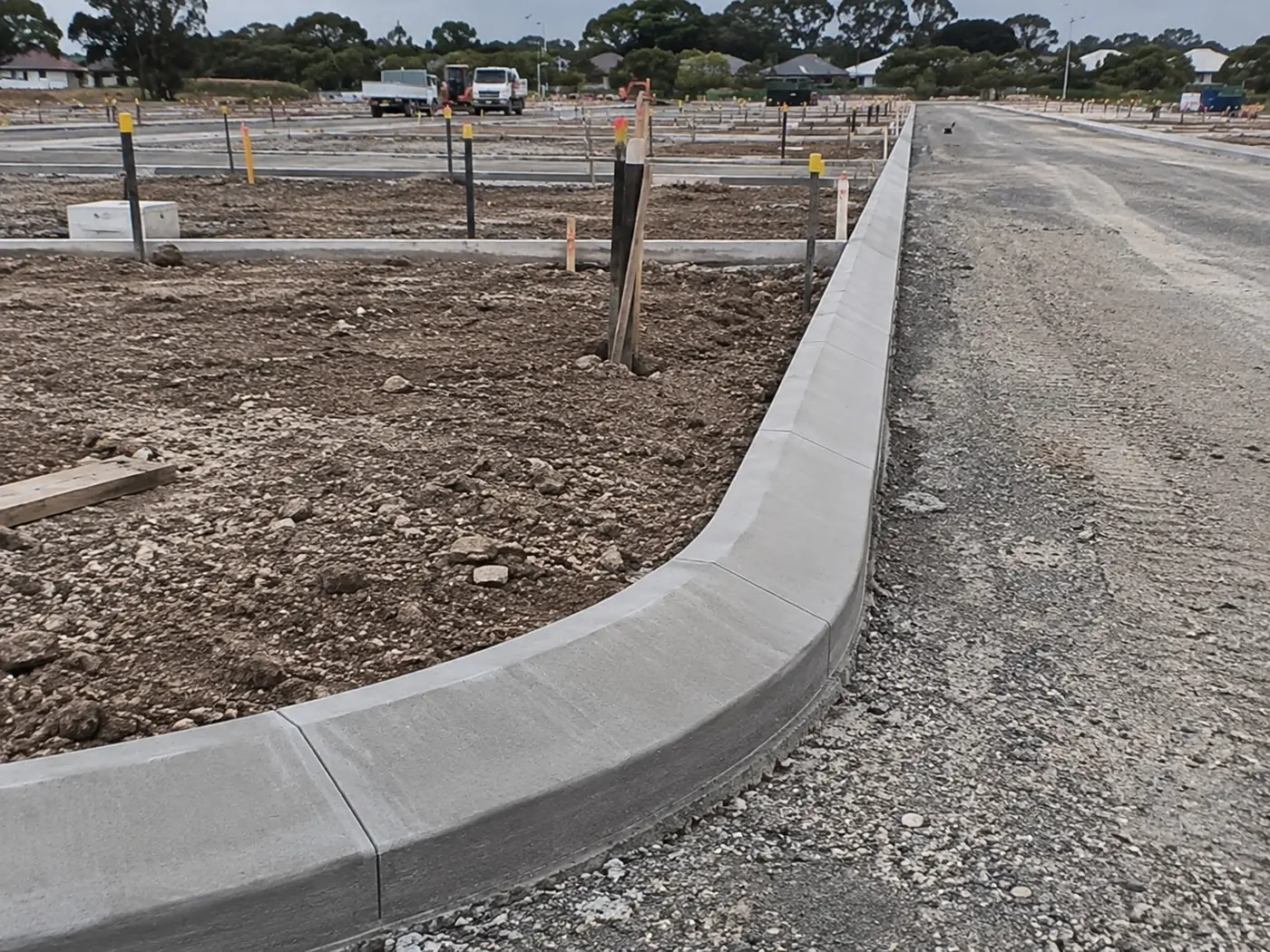 Curved concrete kerb return at a new road intersection