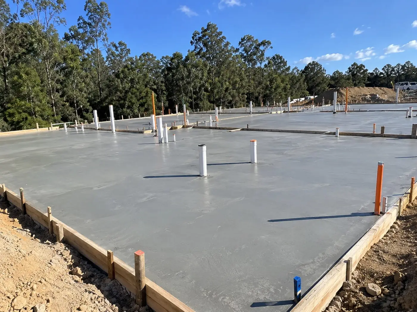 Newly finished engineered concrete slab inside timber edge formwork