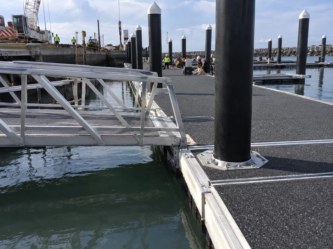 Pontoon walkway, piles and gangway landing at a marina